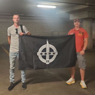 Kowalczyk is wearing gray T shirt and jeans, Dirzys is wearing orange polo and a baseball cap with orange sunglasses on top