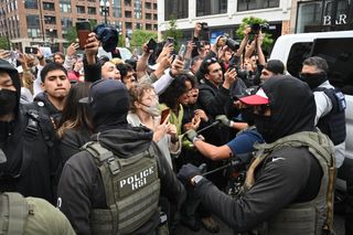 protesters face off with masked and hooded ICE agents in body armor