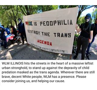 James Hammans and his partner "Annie" holding banner at Pride protest. it reads "pride is pedophilia / destroy the trans agenda"